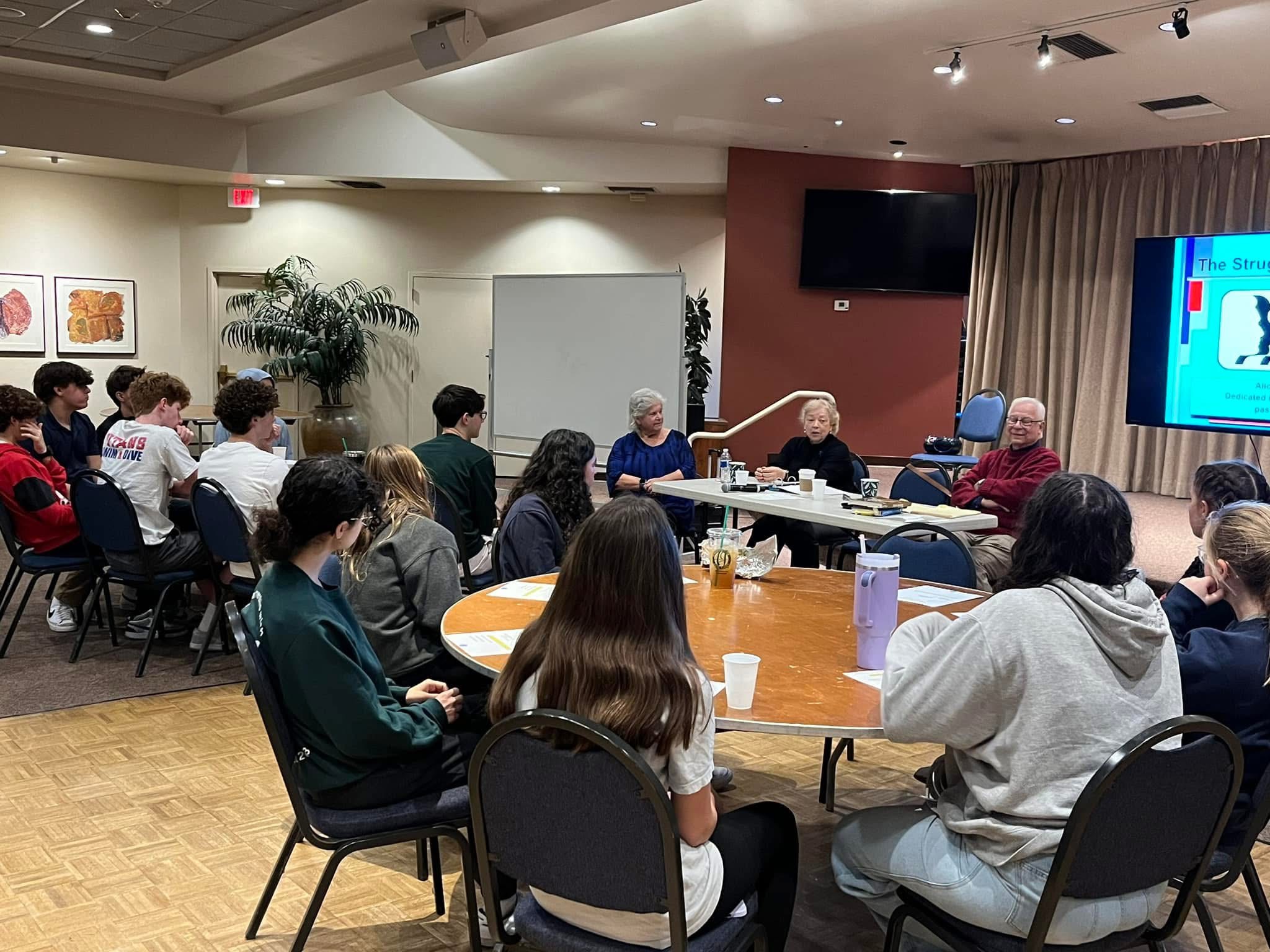 Members gathering around tables